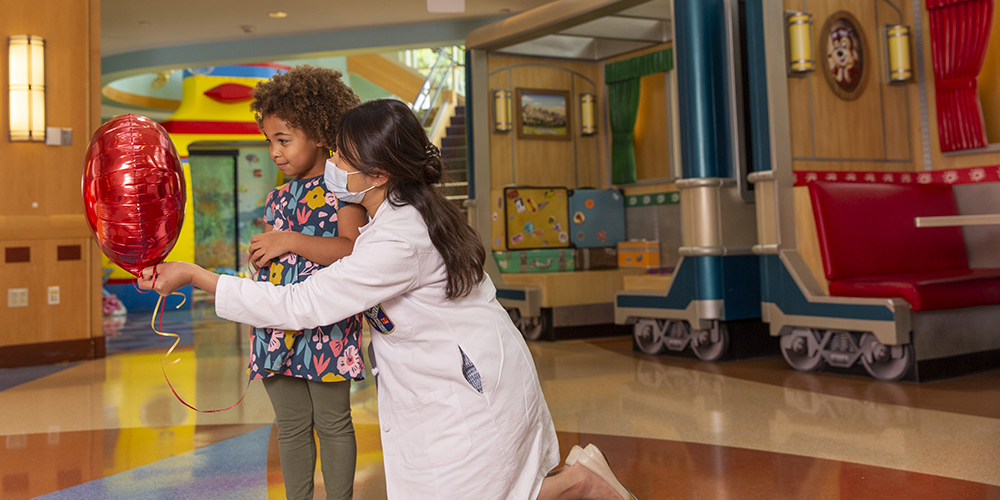 outside-costa-center-girl-holding-balloon-with-doctor