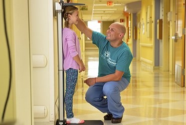 Young girl being measured