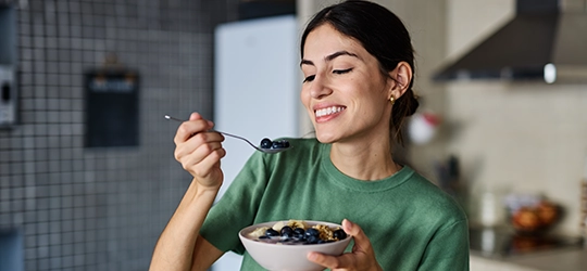 Woman eating breakfast.