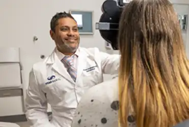 Provider giving patient eye exam