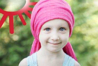 young girl with cancer smiling at camera