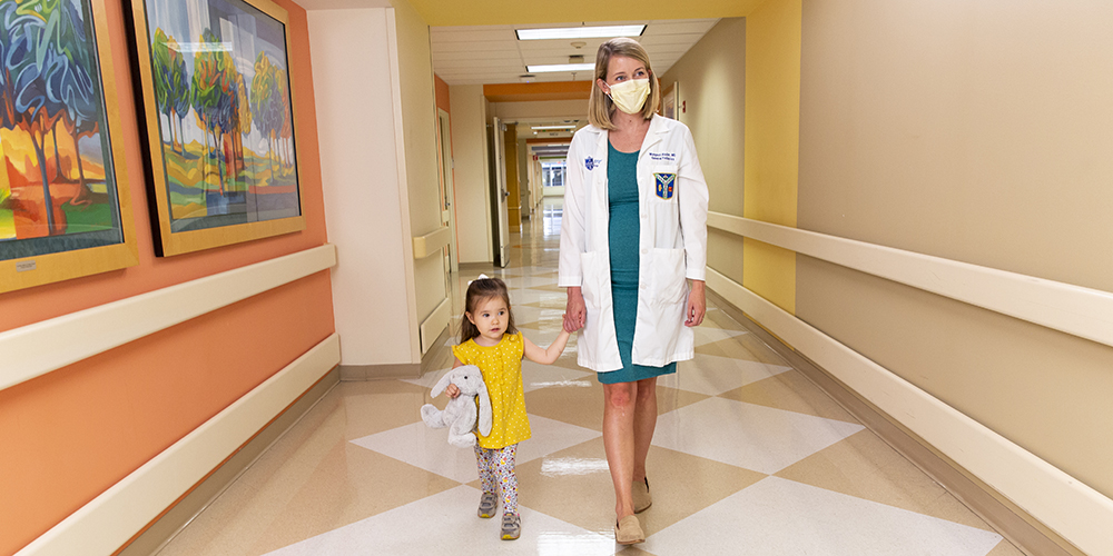 doctor-and-child-walking-down-hallway-in-cardinal-glennon