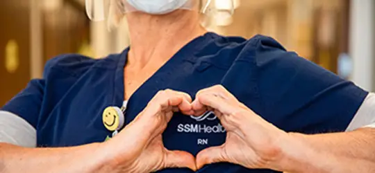 nurse making a heart with the shape of her hands