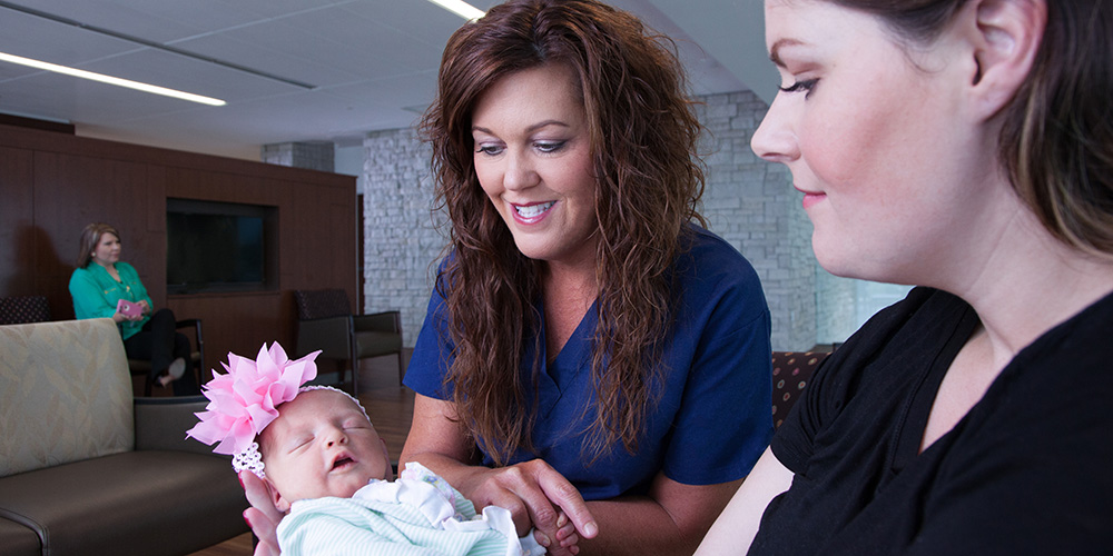 woman-and-nurse-holding-baby