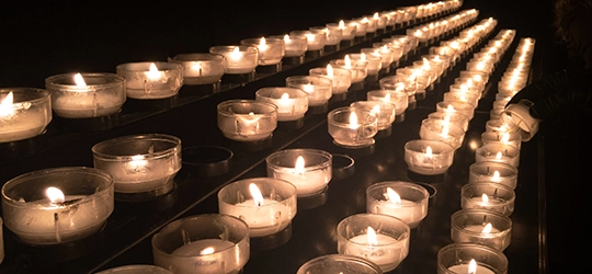 Rows of lit candles.