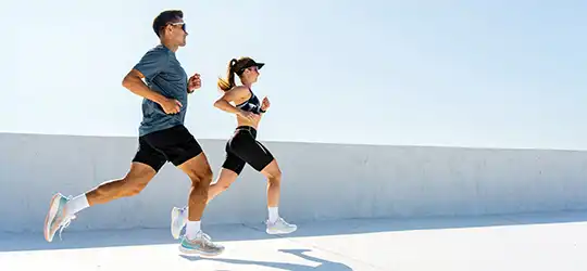 couple running on roadway