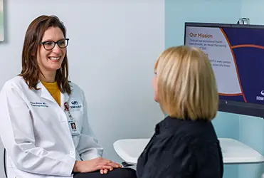 Woman and doctor consult in office