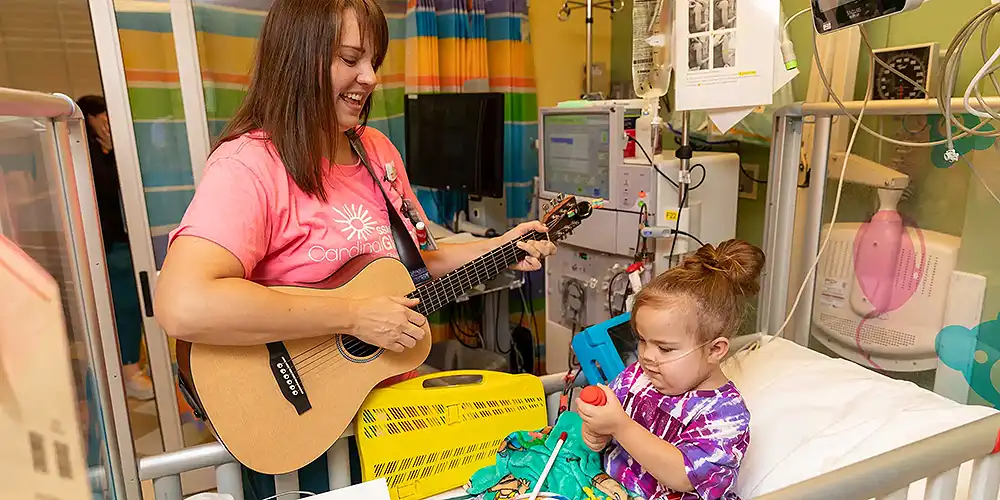 music-therapist-with-toddler-girl-hospital-bed