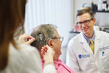  Dr. Anthony Mikulec fitting patient with a cochlear implant