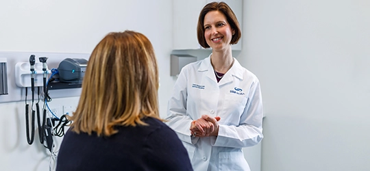 dr. dana hankel talking to patient at high risk breast clinic