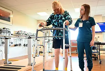 SSM Health physical therapist helping patient relearn to walk