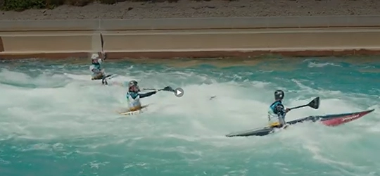 Athletes canoeing on river.
