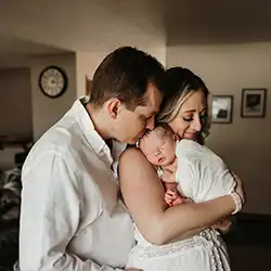 muir family kissing and holding infant