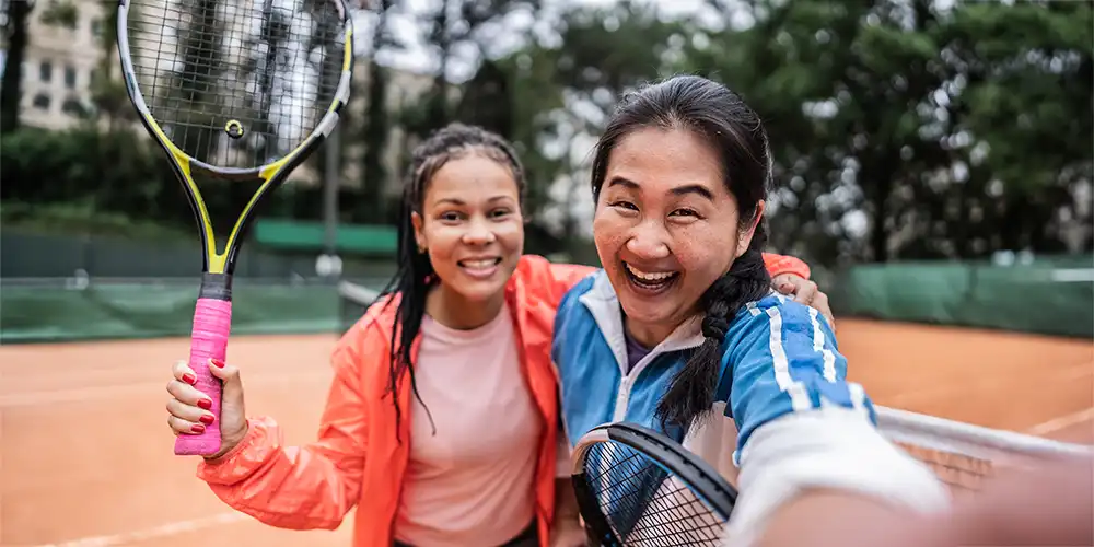 two women taking a selfie after playing tennis