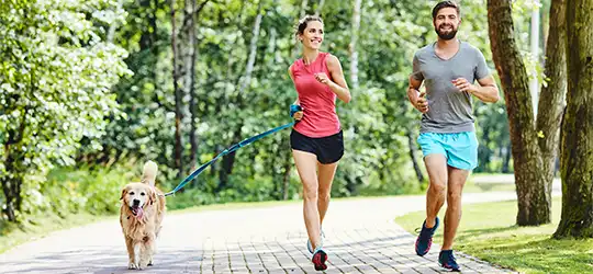 couple running with dog