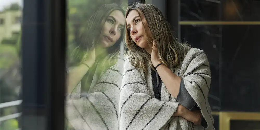 woman leaning against window reflecting