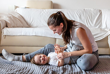 Mother playing with child.