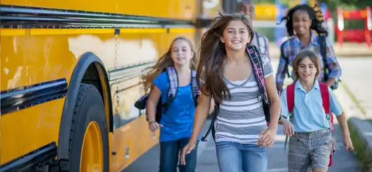 Kids getting off of the bus