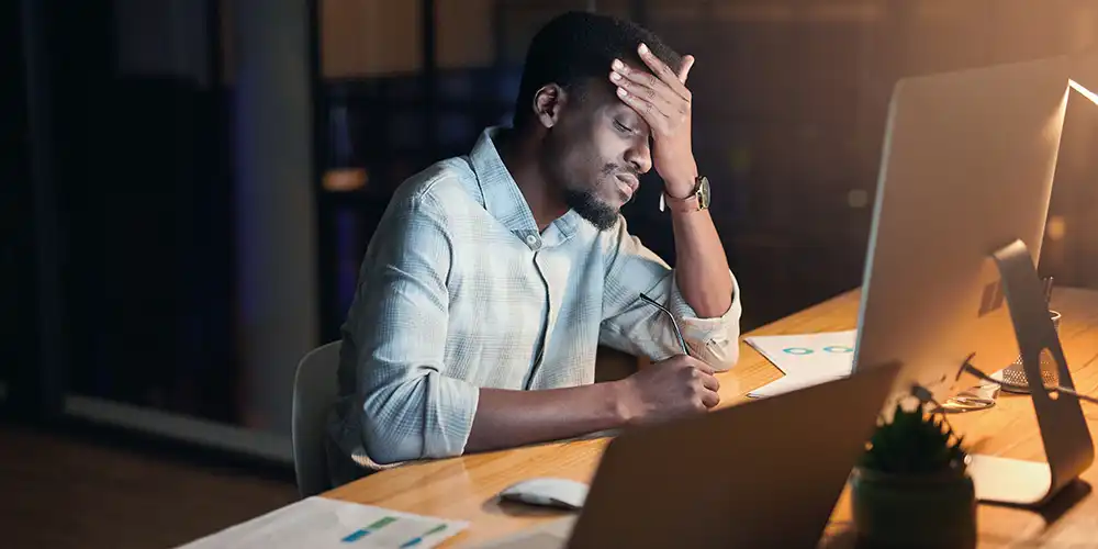 man stressed at desk while working