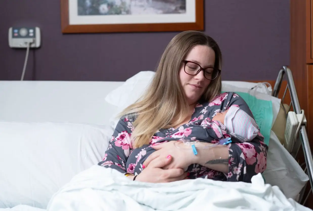 woman in hospital bed holding baby