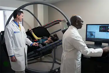 Dr. Mikulec and Dr. Harris treat a patient with balance issues