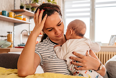 sad woman holding baby
