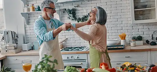 older couple dancing in kitchen