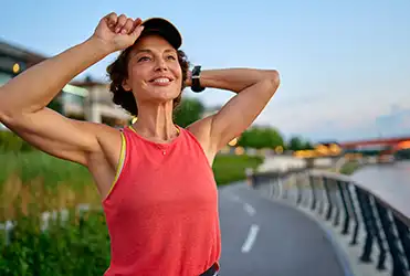 woman smiling on a running path