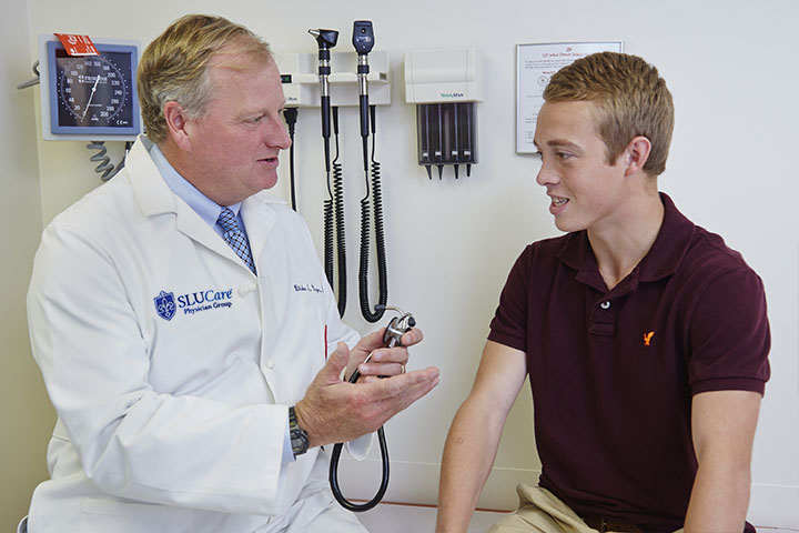 doctor speaking to young patient with cystic fibrosis