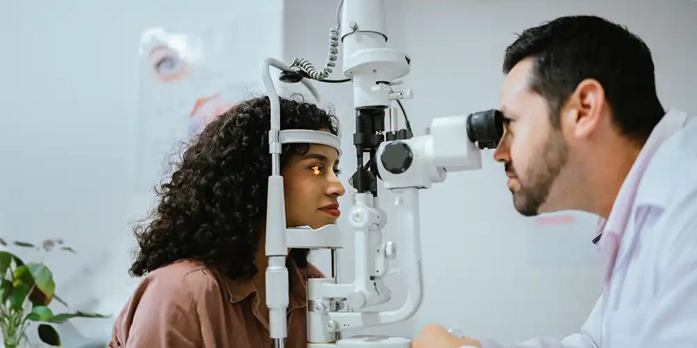 eye doctor checking woman's eyes