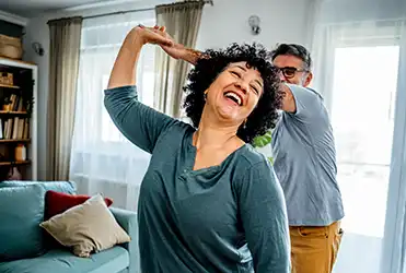 couple dancing in living room 