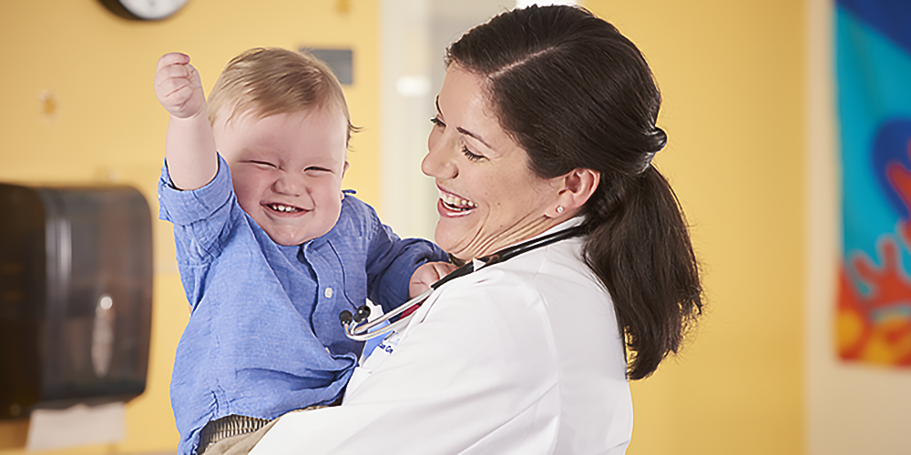 woman doctor holding young child