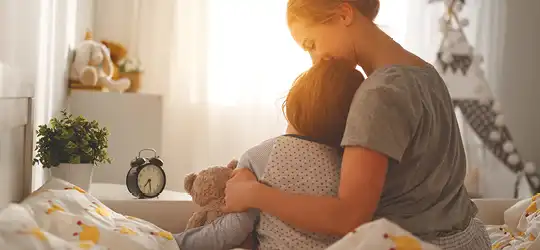 Mother hugging child