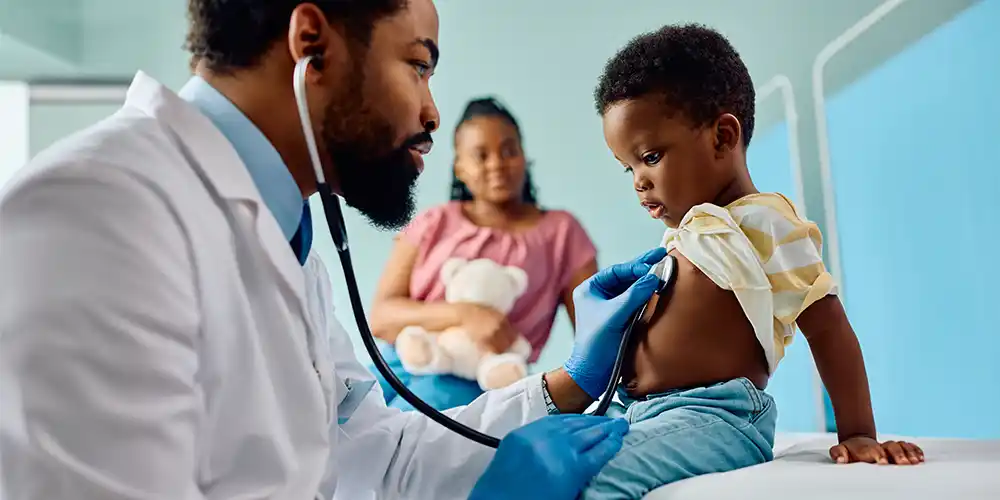 provider examining young boy in emergency room