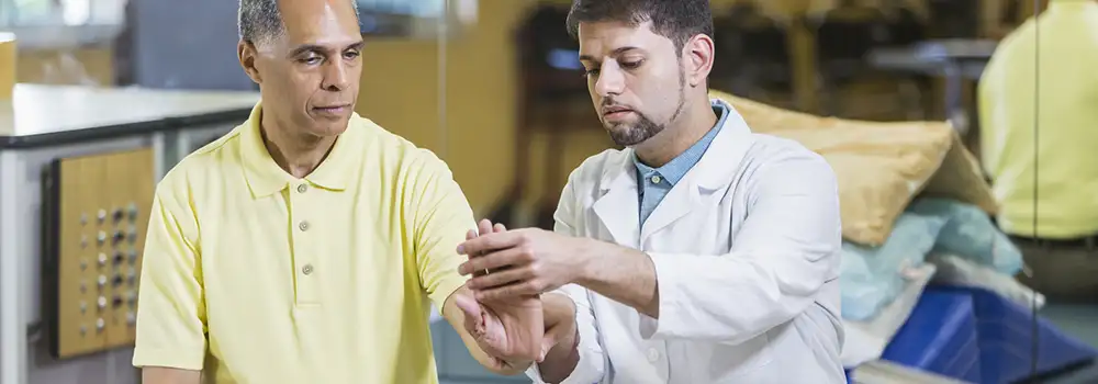 doctor testing wrist mobility in patient