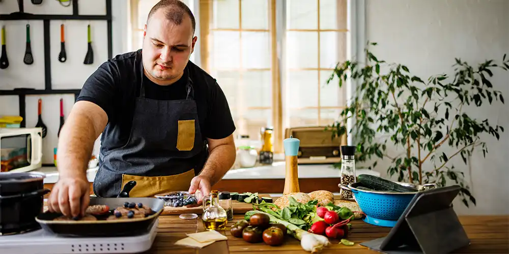 man cooking a healthy meal