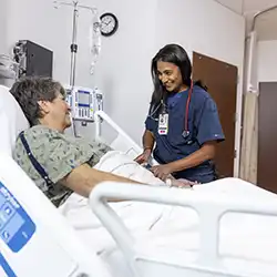 nurse bedside helping patient