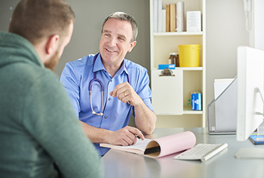 Young man talking to doctor