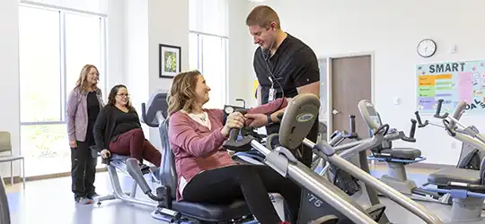 woman at a gym working out on a bike