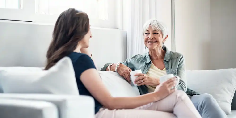 Woman having coffee with senior