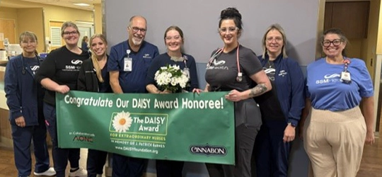 Emily Cox receiving DAISY Award.
