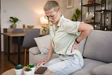 woman holding flank in pain