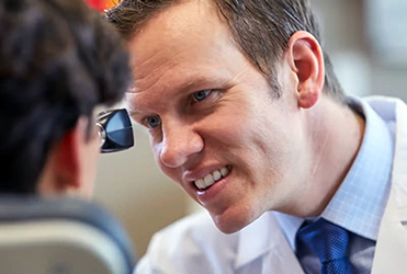 Dr. Brunworth, otolaryngology, examines patient