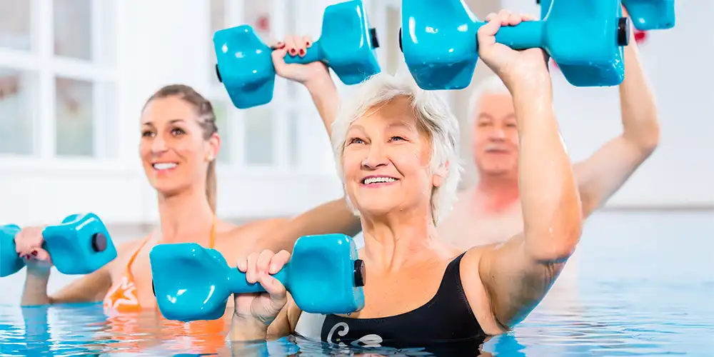 senior woman taking water aerobics class 