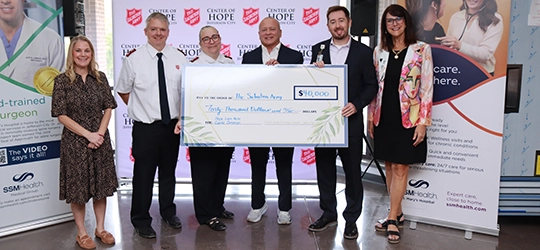 SSM Health and Salvation Army team with grant check.