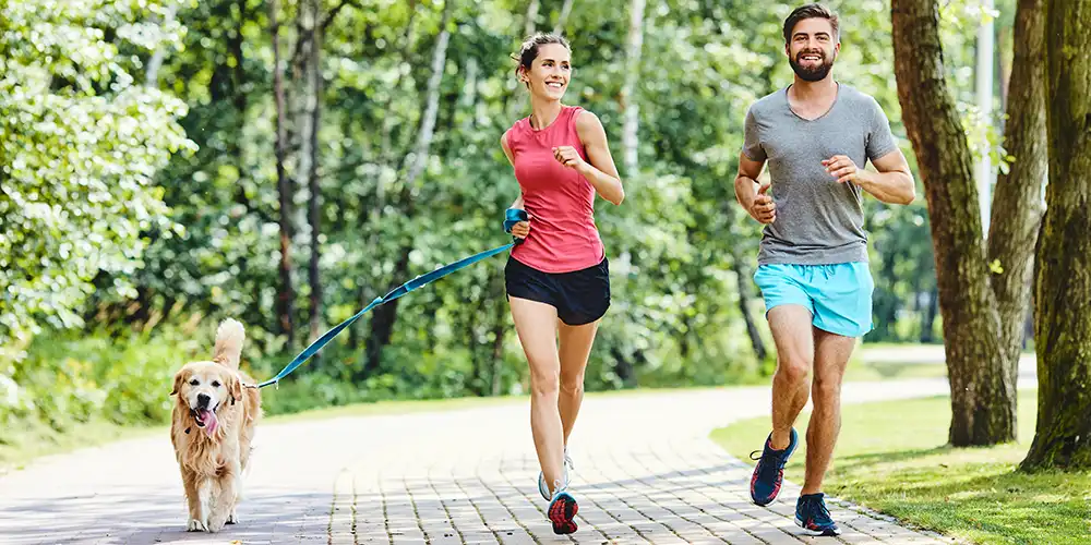 couple running with dog