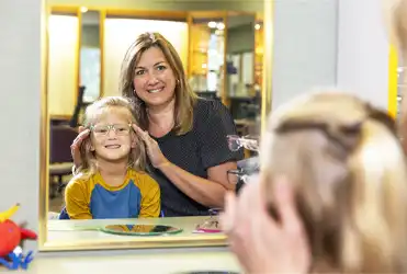 child being fit for eye glasses