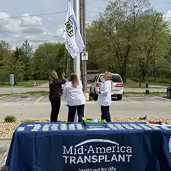 staff raising the transplant flag