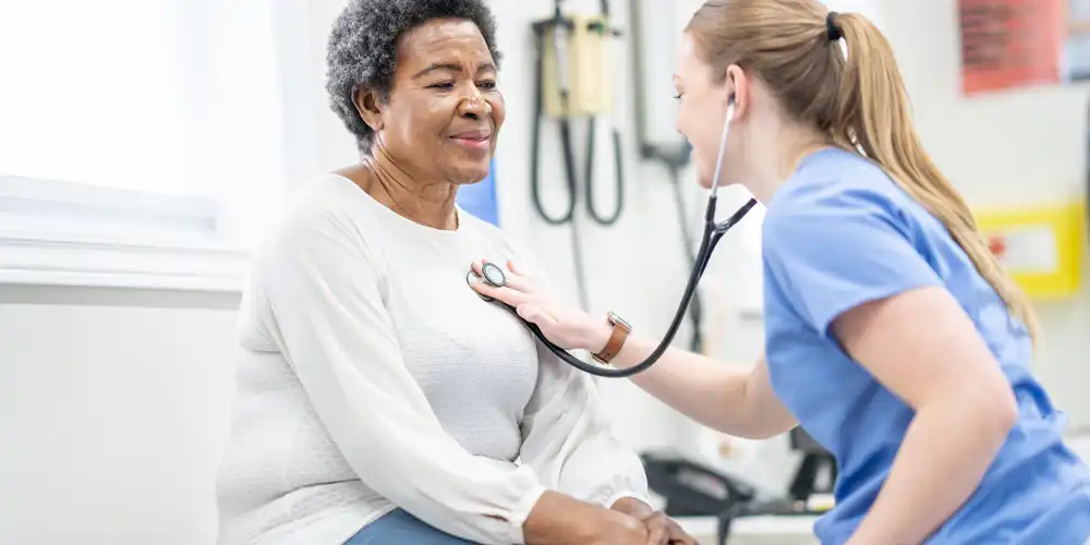 Provider listening to patient's heart