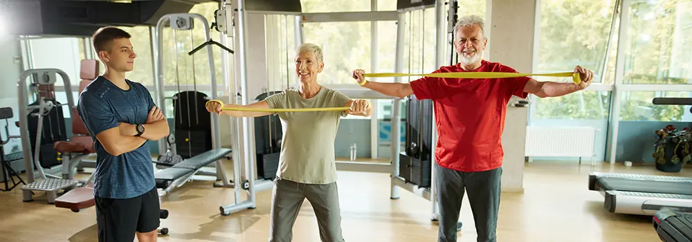 woman and man exercising with bands